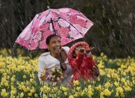 African mother and daughter playing in the rain