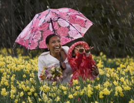 African mother and daughter playing in the rain