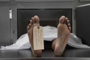 'Cadaver on autopsy table, label tied to toe, close-up'