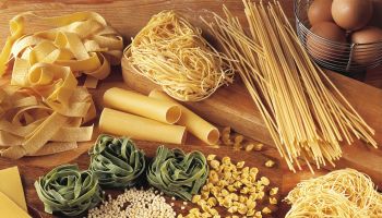 High angle view of assorted pasta and ingredients