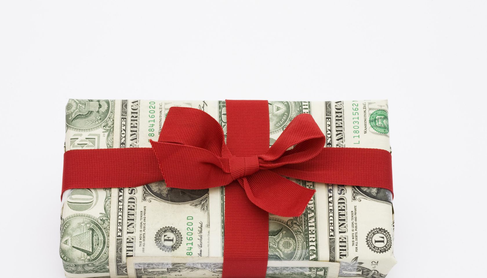 A gift wrapped in dollar bills