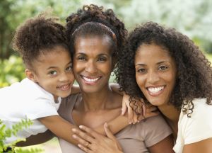 Three generations of women smiling together