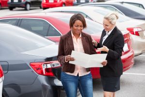 Car salesperson with a customer