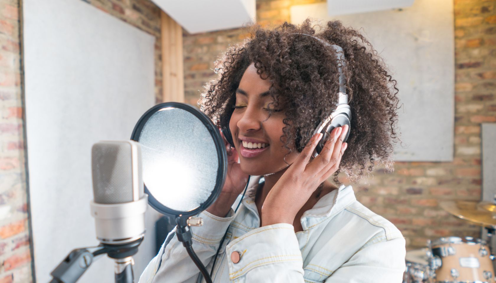 Woman singing at a recording studio