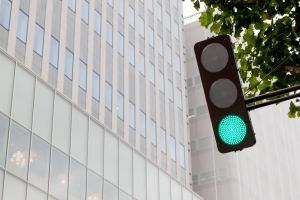 Low Angle View Of Green Light Against Modern Office Building In City