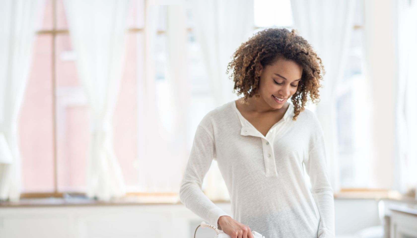 Woman ironing clothes at home