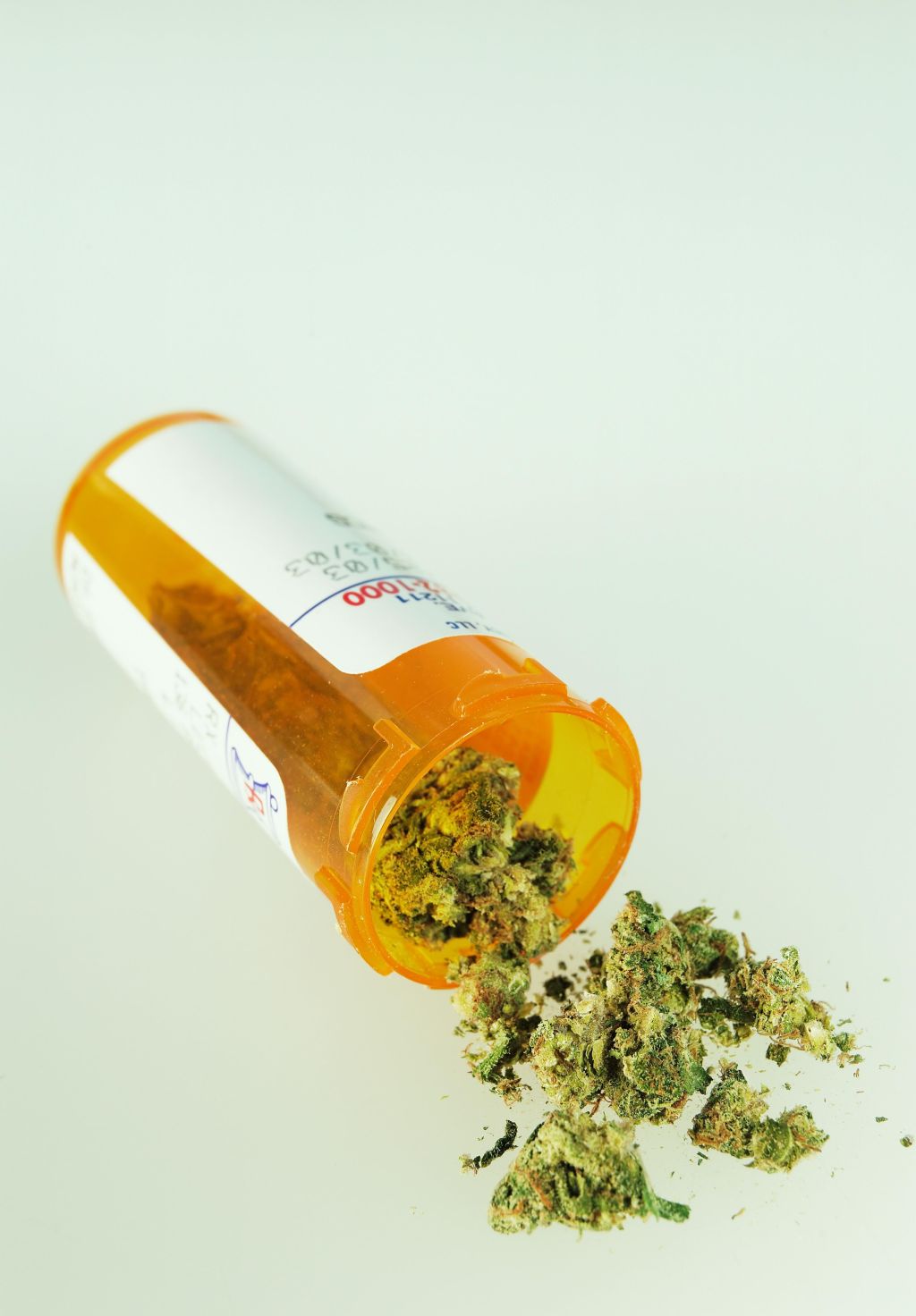 Marijuana spilling out of prescription bottle