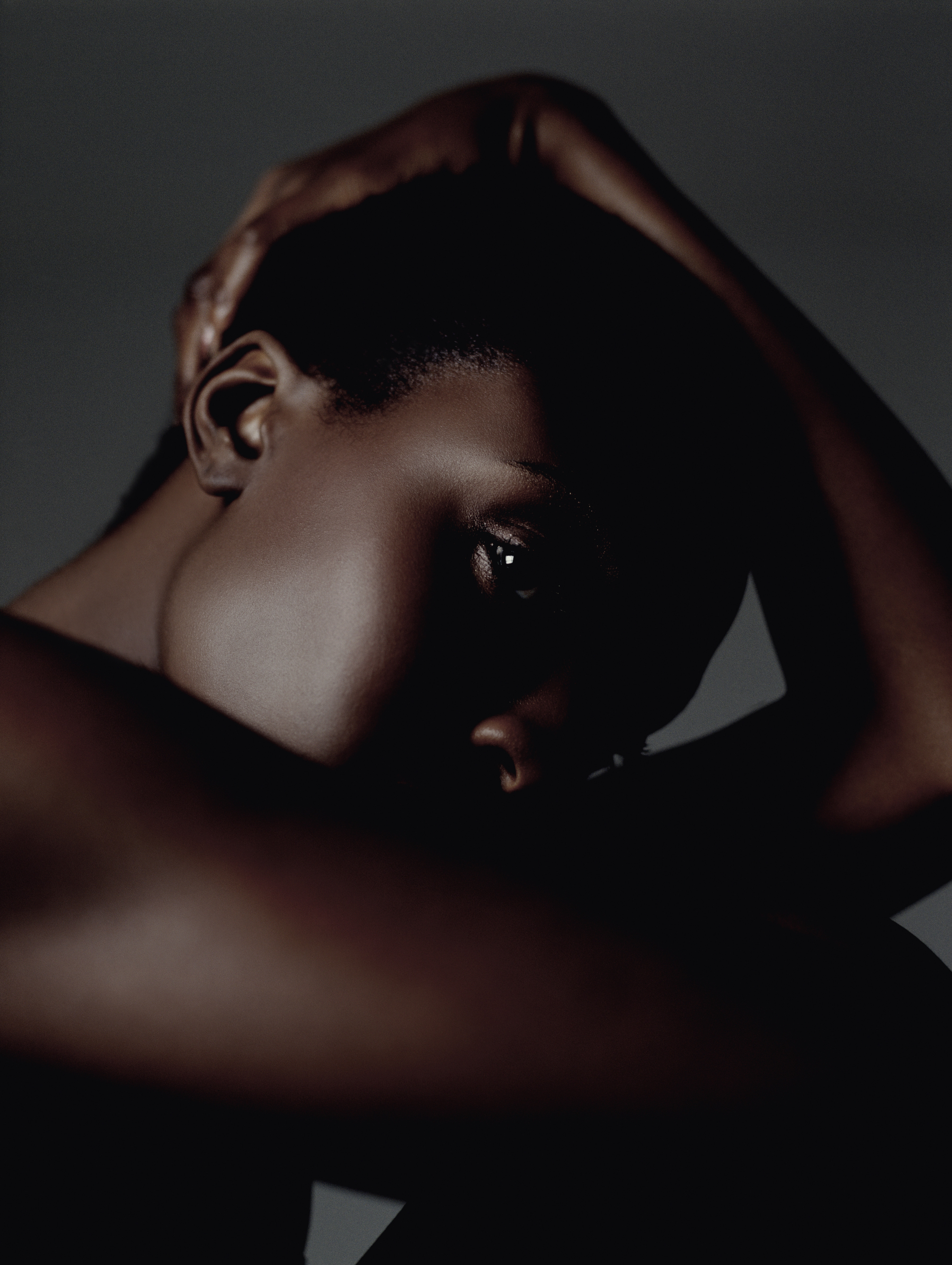 Woman Sits Holding Head