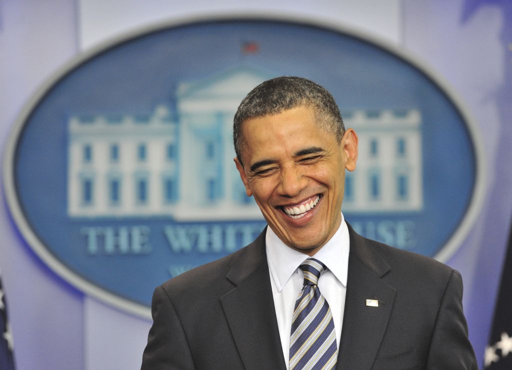 US President Barack Obama smiles as he m