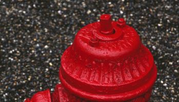 Red fire hydrant, out of service after water main break