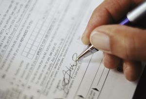 Man Signing Tax Form