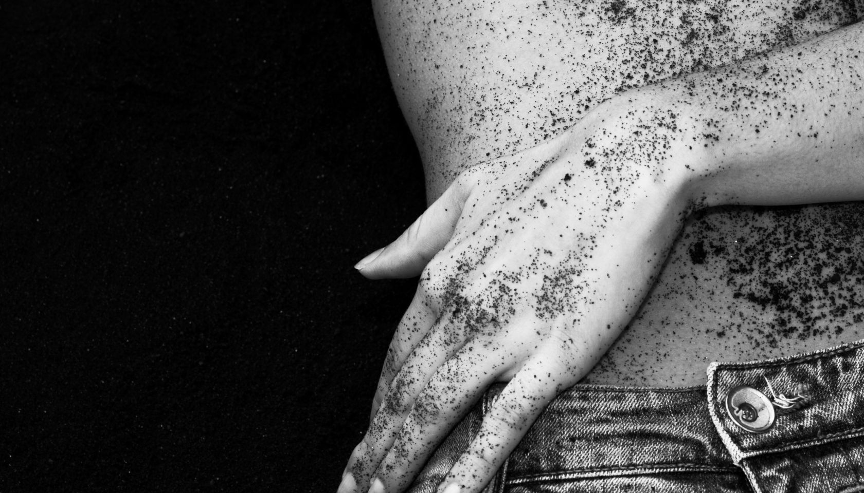 Midsection Of Sensuous Woman Against Black Sand
