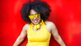 Woman in yellow vest,headphones and sunglasses
