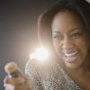 African American woman opening champagne bottle