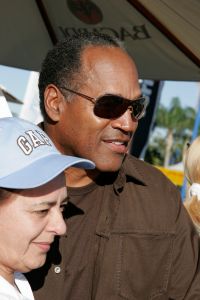 OJ Simpson posing for a photo with a woman at the Arts Festival