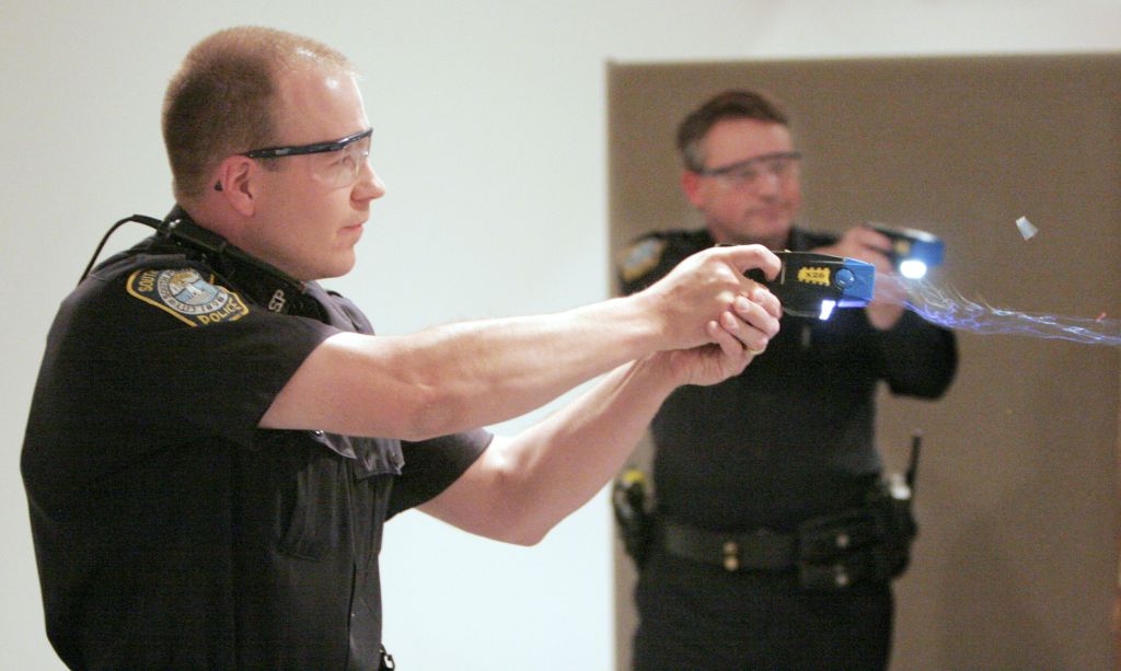 Christopher Todd, an officer with the South Portland police department, fires his taser gun during a
