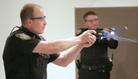 Christopher Todd, an officer with the South Portland police department, fires his taser gun during a