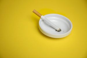 Cigarettes and butts in ashtray