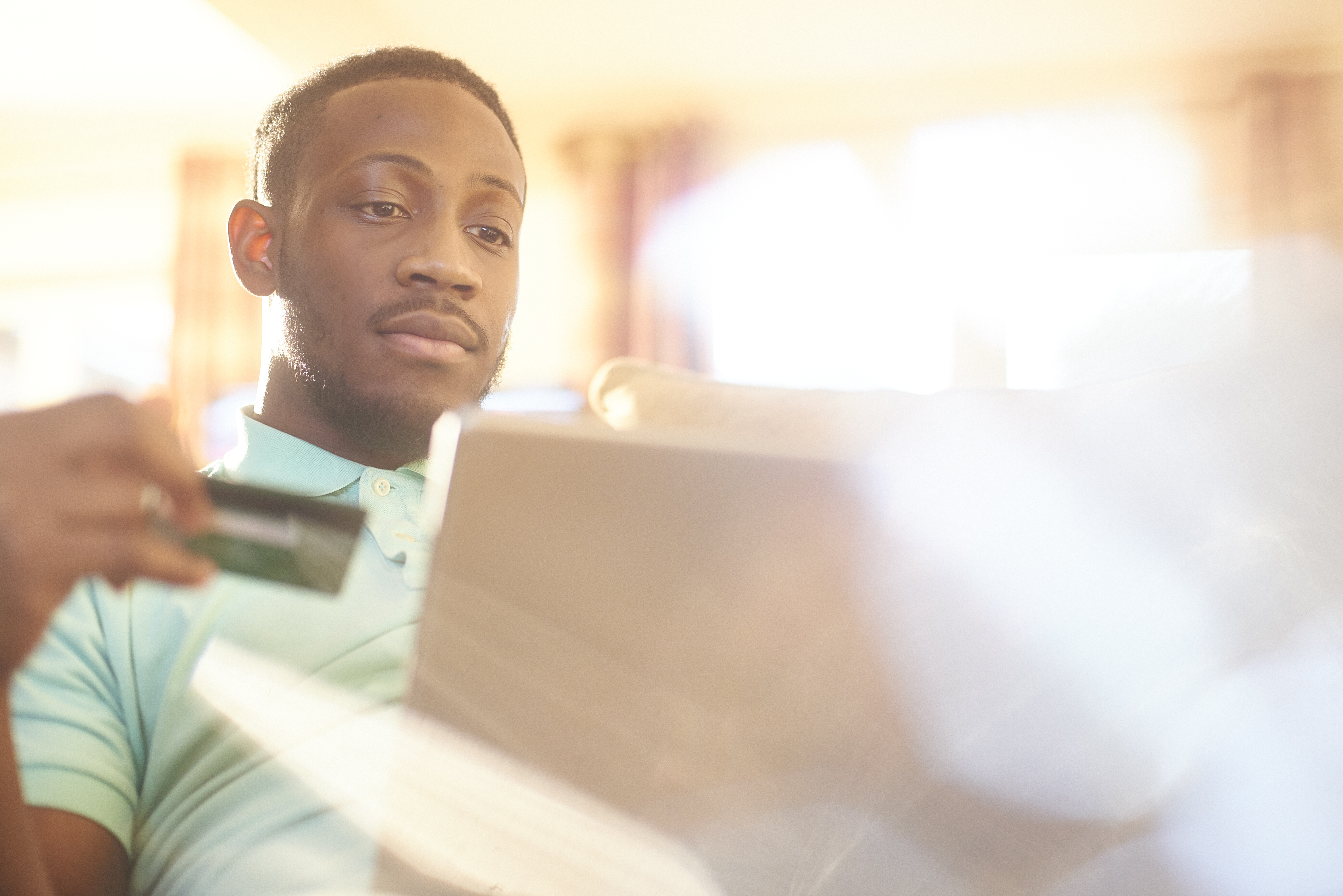 Young black male paying for his online shopping