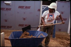 Habitat for Humanity Worker Shovels Dirt Into Wheelbarrow