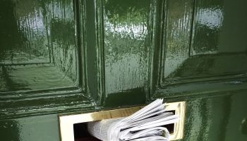 Rolled Newspaper In Mailbox