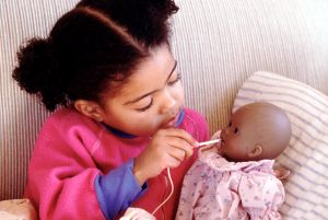 Child caring for sick doll