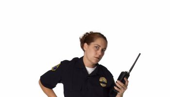 Female Officer Holding Radio With Hard on Gun