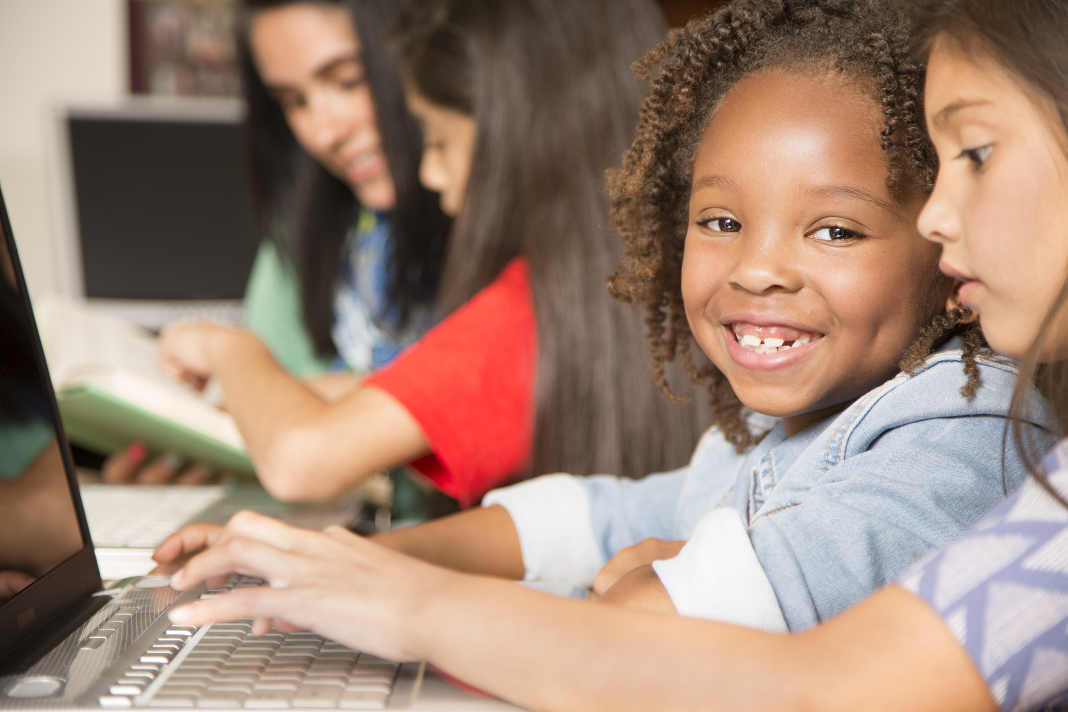 Elementary-age children learn computer coding in school.