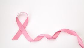 Close-Up Of Pink Ribbon Over White Background