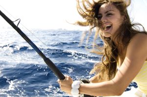 Portrait of a young woman fishing and smiling