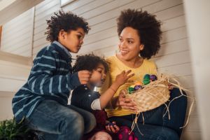 Family holding basket of Easter eggs