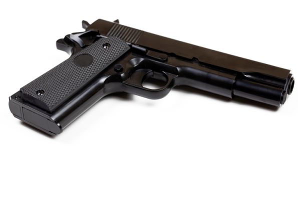Low Angle View Of Gun Over White Background