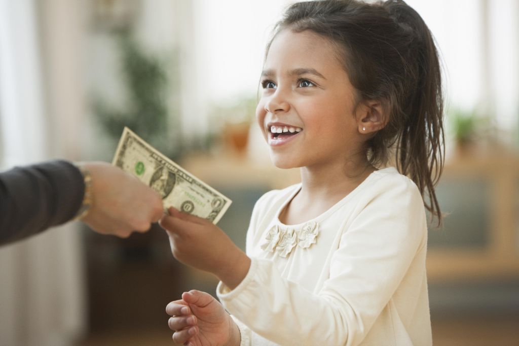 Mother handing girl one dollar bill