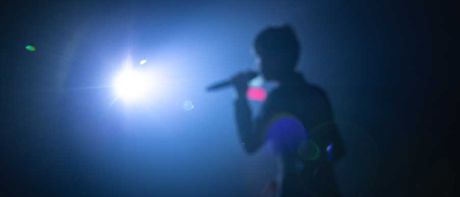 blurred background of singer on concert stage