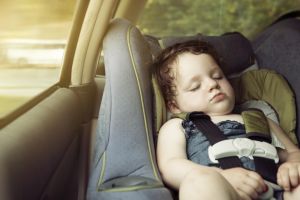 A baby girl in her car seat