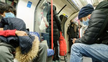 People wearing masks travel on the Victoria Line of the London Underground, London on Friday, Mar. 20, 2020 .