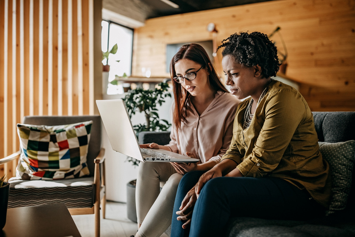 Teamwork Of Two Young Women Working at Office