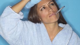 Woman with thermometer and icepack