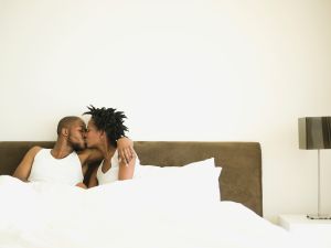 Couple kissing in bed