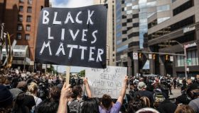 A protester holds a placard that says Black Lives Matter...