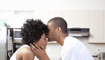 Couple kissing in kitchen