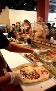 Amina Gunn Assembles A Chicken Queso Burrito At Qdoba