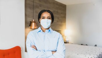 Confident housekeeping manager in hotel room