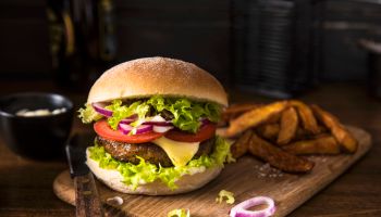 Cheeseburger with tomatoes, onion and lettuce