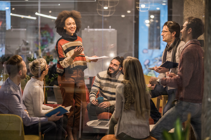 Group of happy business people talking on a constructive meeting in the office.