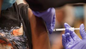 Anyla Wade-Bacon, 13, of Columbus, Ohio receives the vaccine...