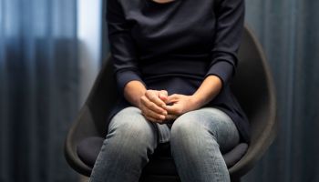 Mid section of woman sitting during meeting