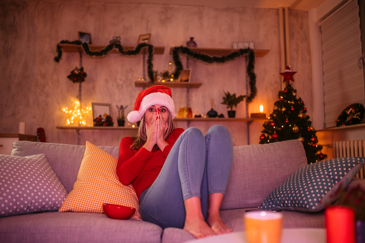 Woman watching movie at home during Christmas