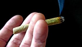 A smoking marijuana joint in man's hand