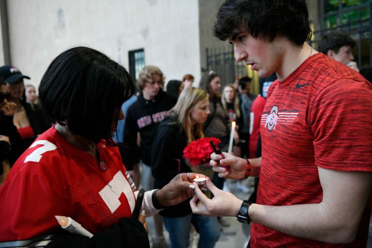Fans and students attend a candlelight vigil in memory of Dwayne Haskins at Ohio Stadium